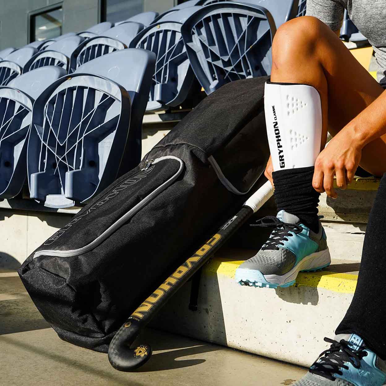 close up of a player's foot pulling a sock over the shinguard