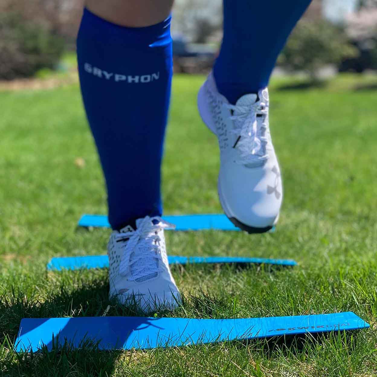 close up of a field hockey player running through the Kwikgoal Flat Rectangle Markers