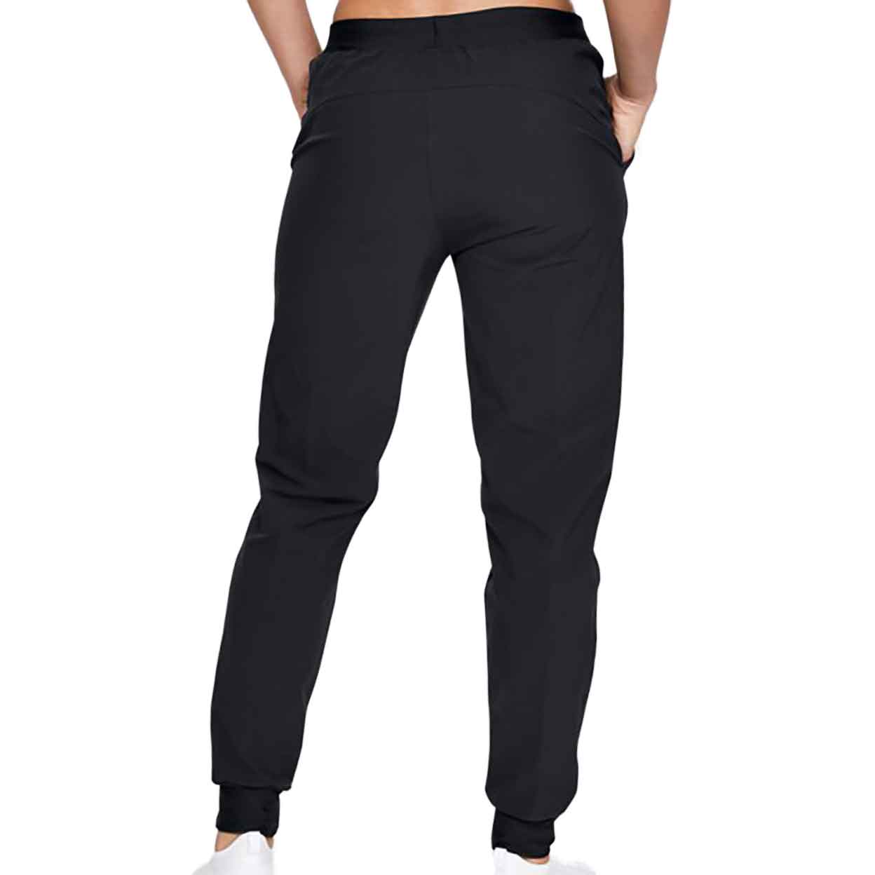 Back view of a model wearign Under Armour Women's Woven Pants with hands in pockets