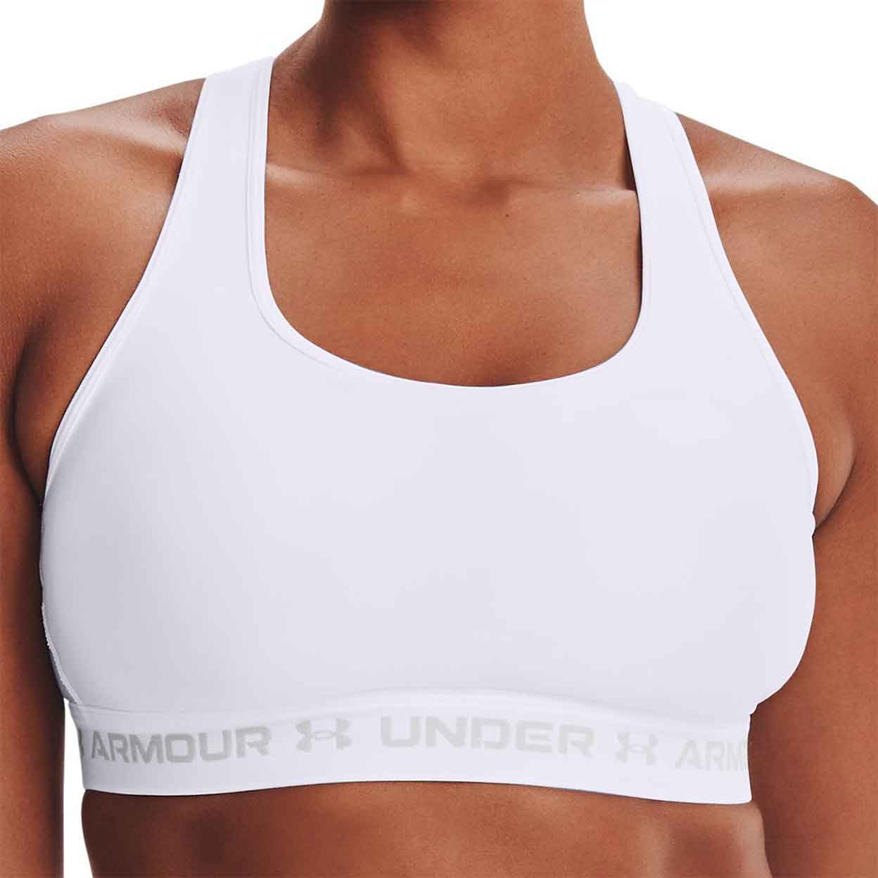 Front of a model wearing the white Under Armour Crossback Mid Bra.