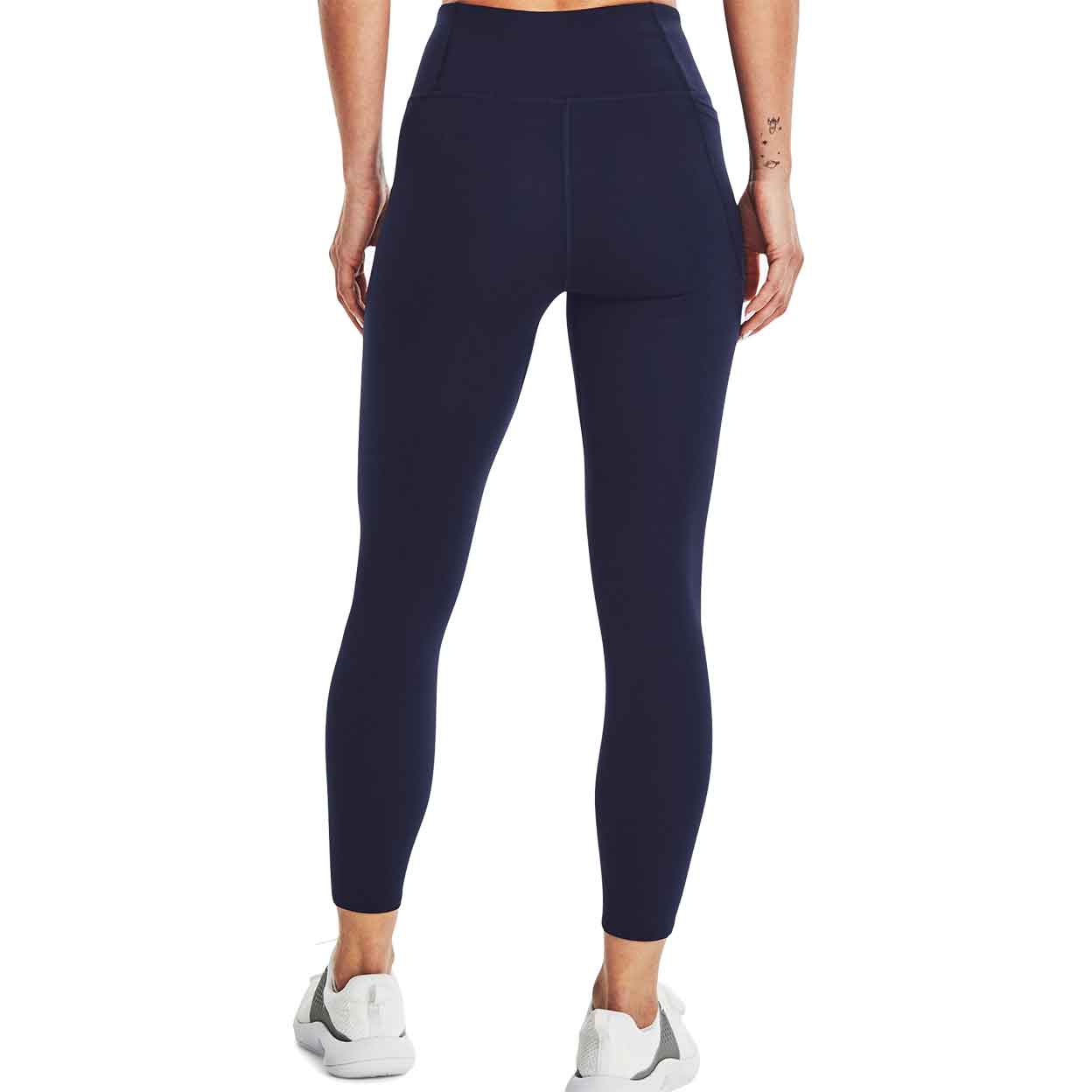 Back of Model wearing Under Armour Women's Motion Ankle Leggings with hands to her side.