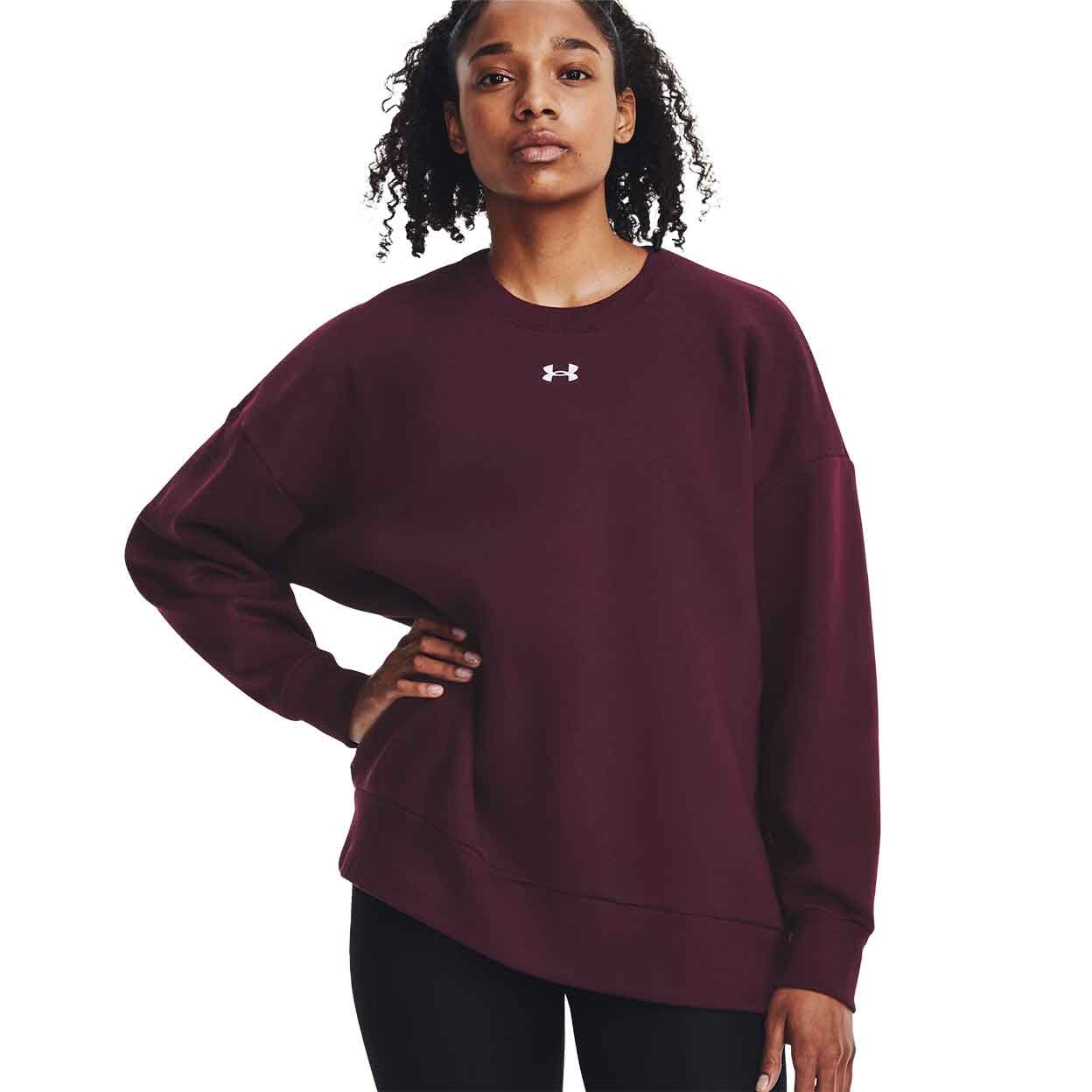 model wearing the red Under Armour Rival Fleece Crew with one hand on her hip.
